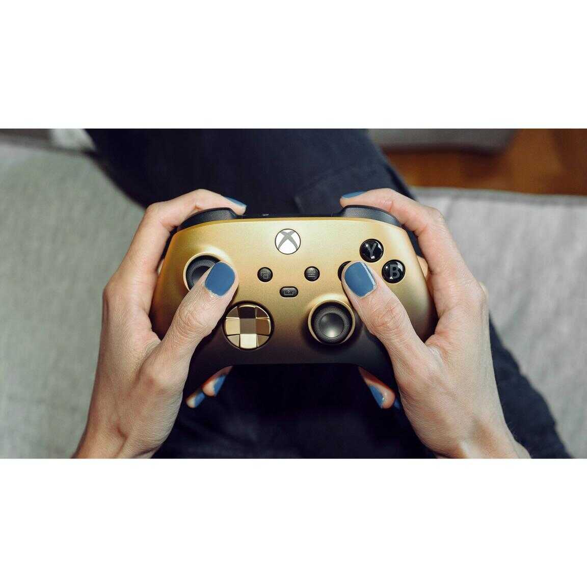 Gold Shadow Special Edition Xbox Series X wireless controller in hands.