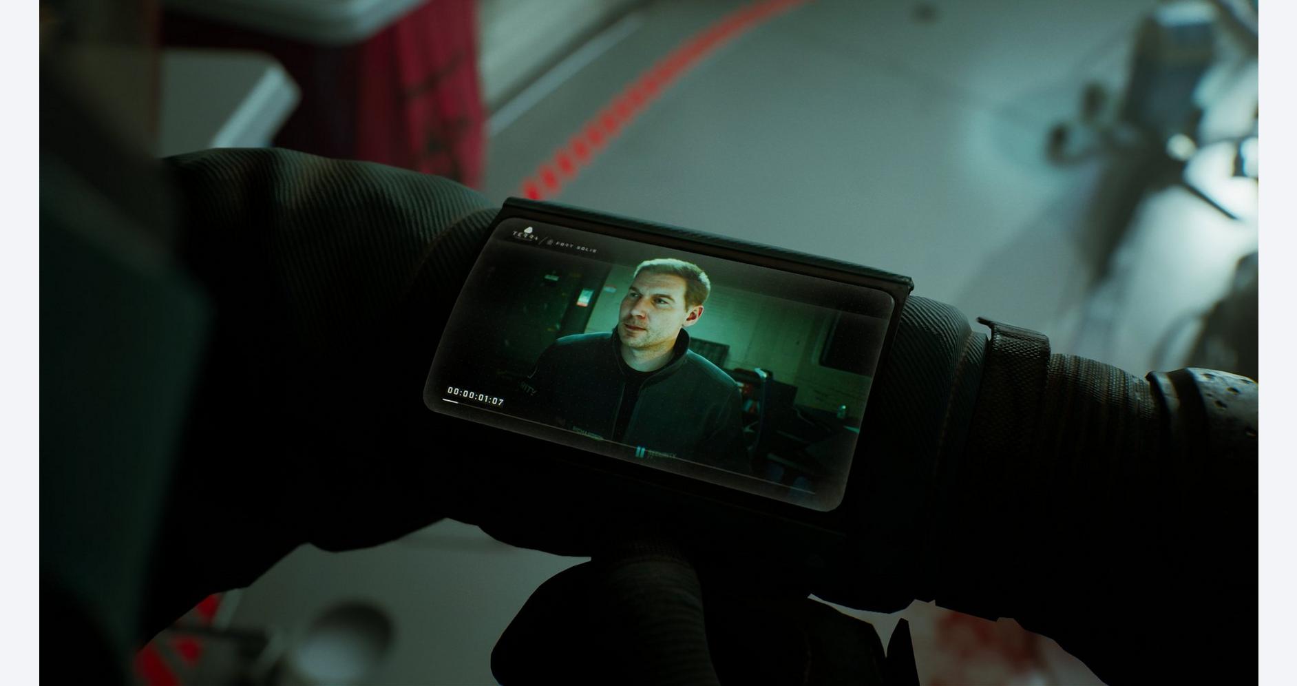 Close-up of a professional video camera capturing a scene with a man on a monitor.