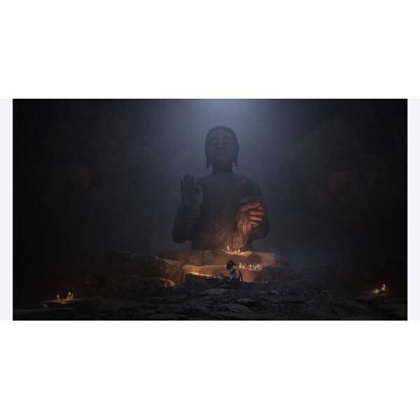 Large Buddha statue in a dark, misty environment with candles and a person sitting nearby.