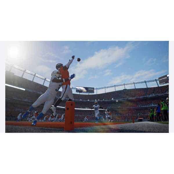 Football players competing for the ball in a stadium during Madden NFL 27.