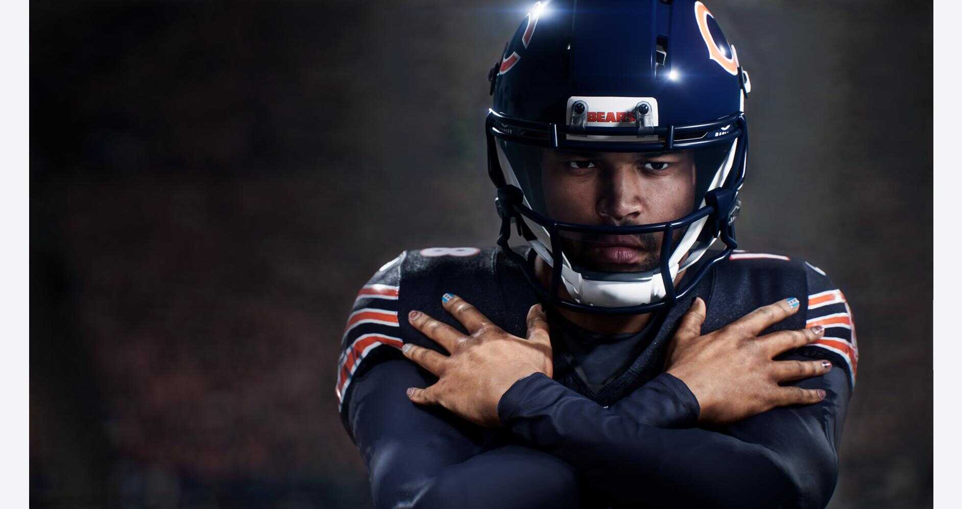 Football player in helmet and uniform, focused and ready for action.