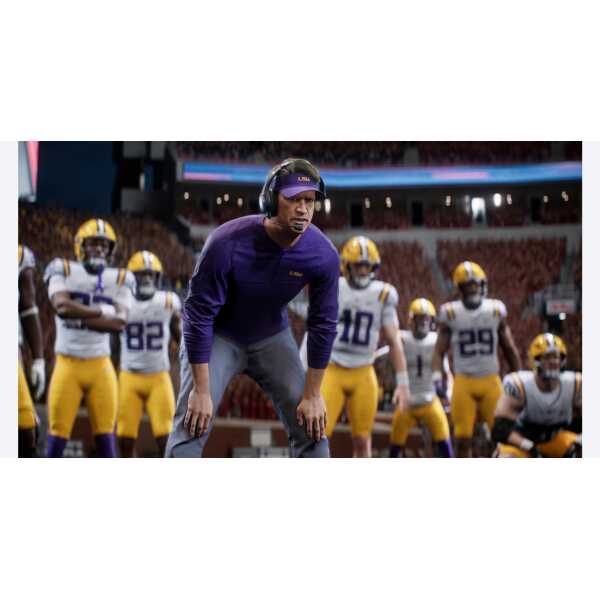 Football coach with players on the sidelines during a game.
