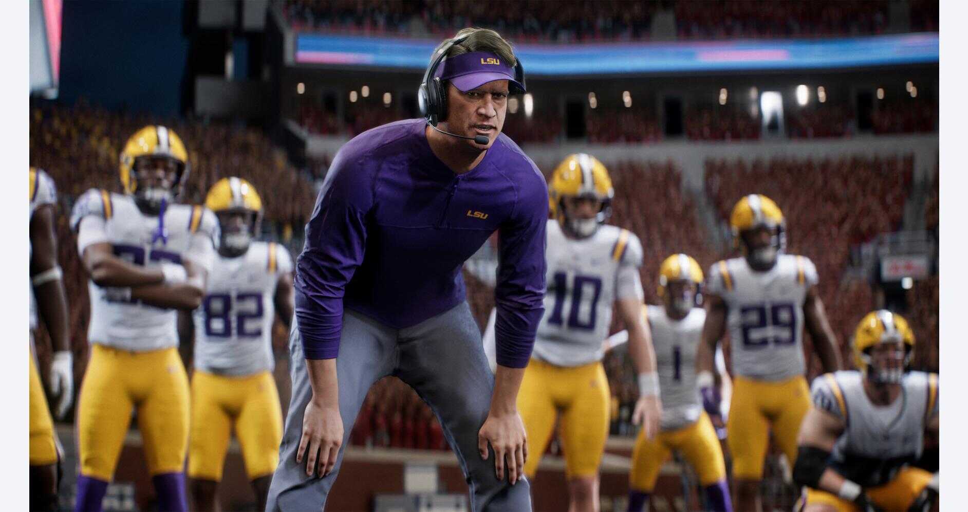 Football coach with players on the sidelines during a game.