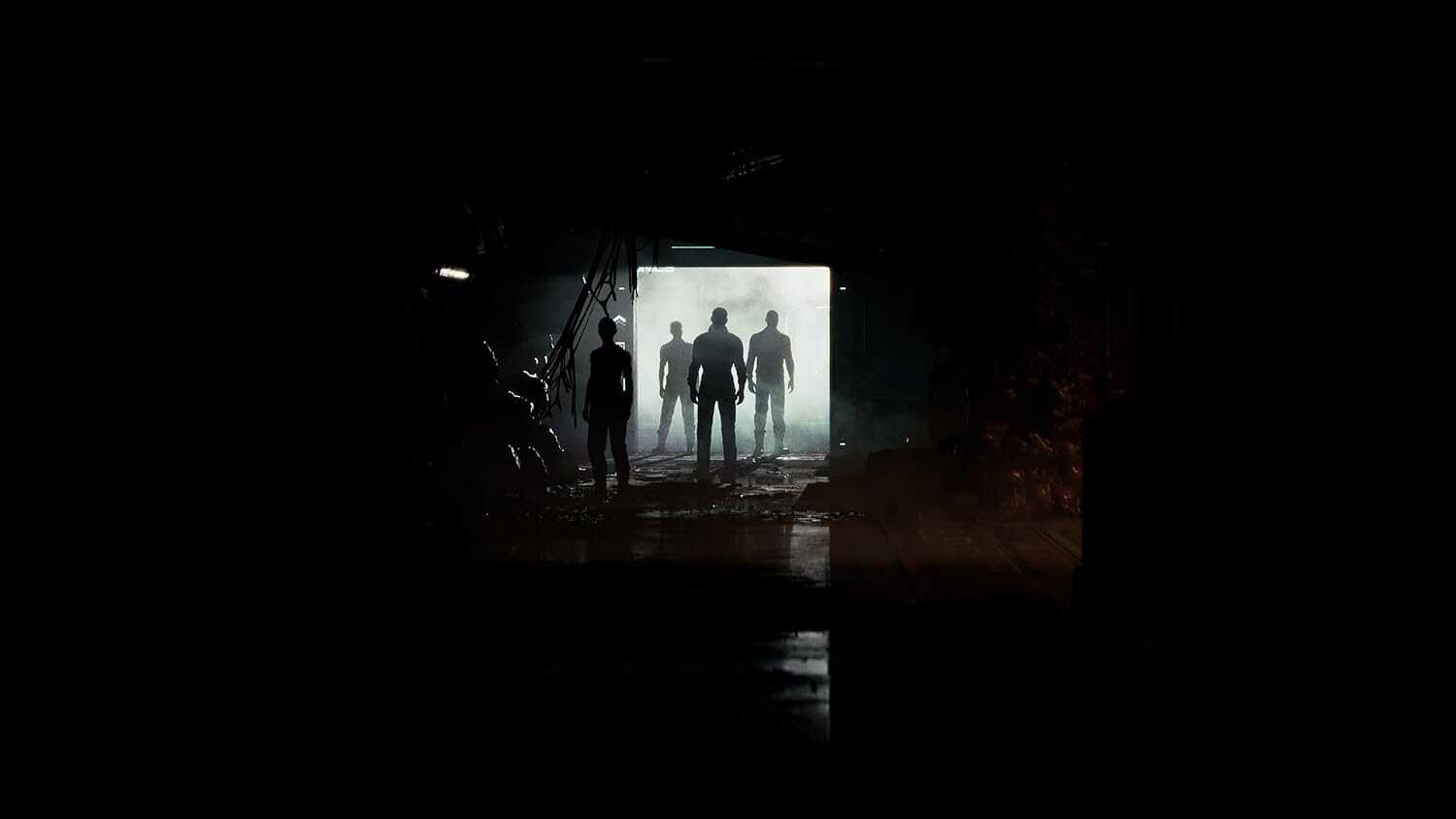 Silhouettes of four people in a dark, mysterious tunnel with light at the end.