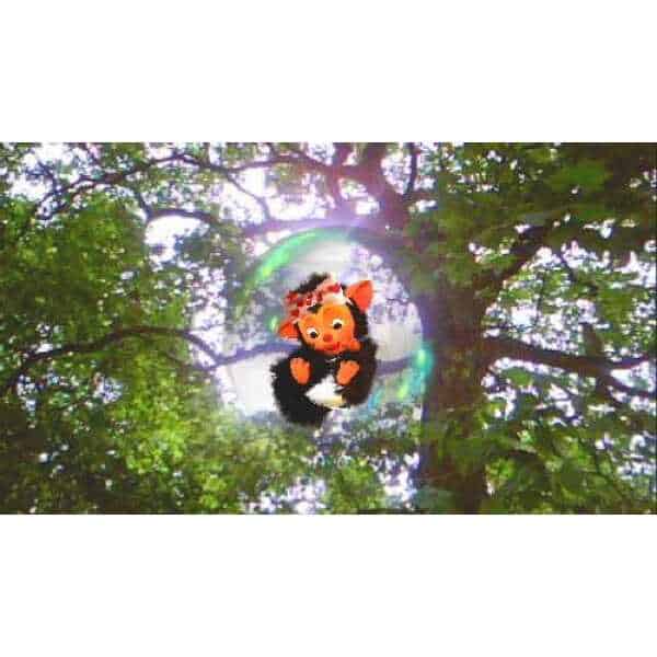 EyePet character hanging from a tree branch in a lush forest setting.