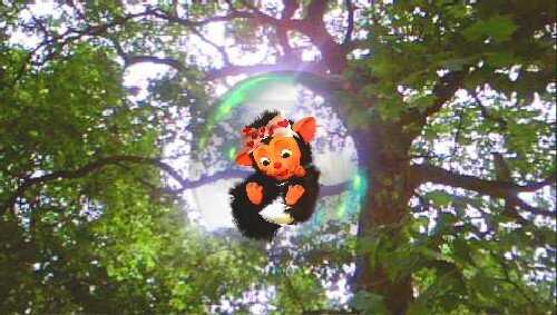 EyePet character hanging from a tree branch in a lush forest setting.