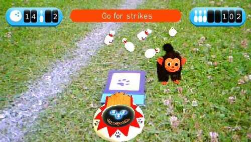 EyePet virtual pet game with a monkey character and interactive elements on grass.