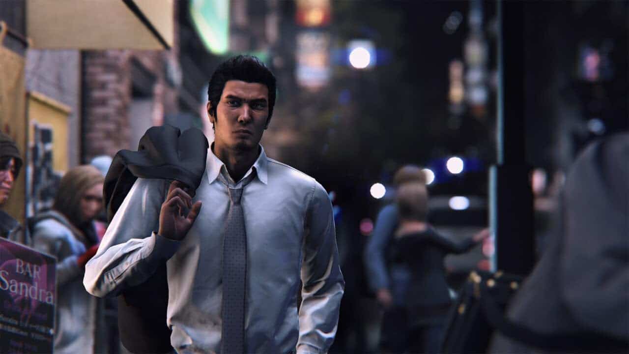 A man in business attire walking on a busy city street at dusk.