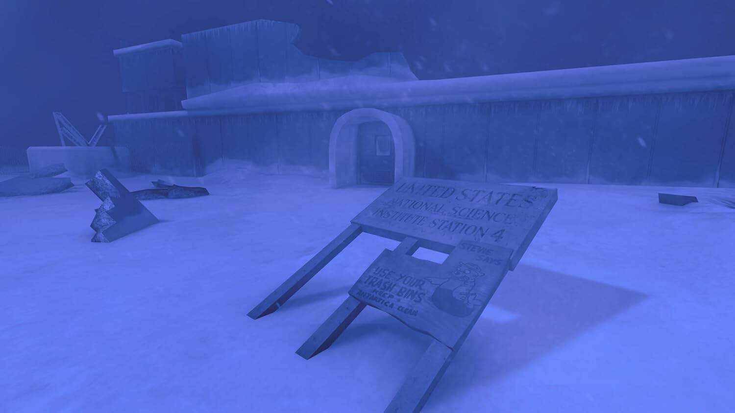 Snow-covered landscape with gameware signage and structures in a cold, winter setting.