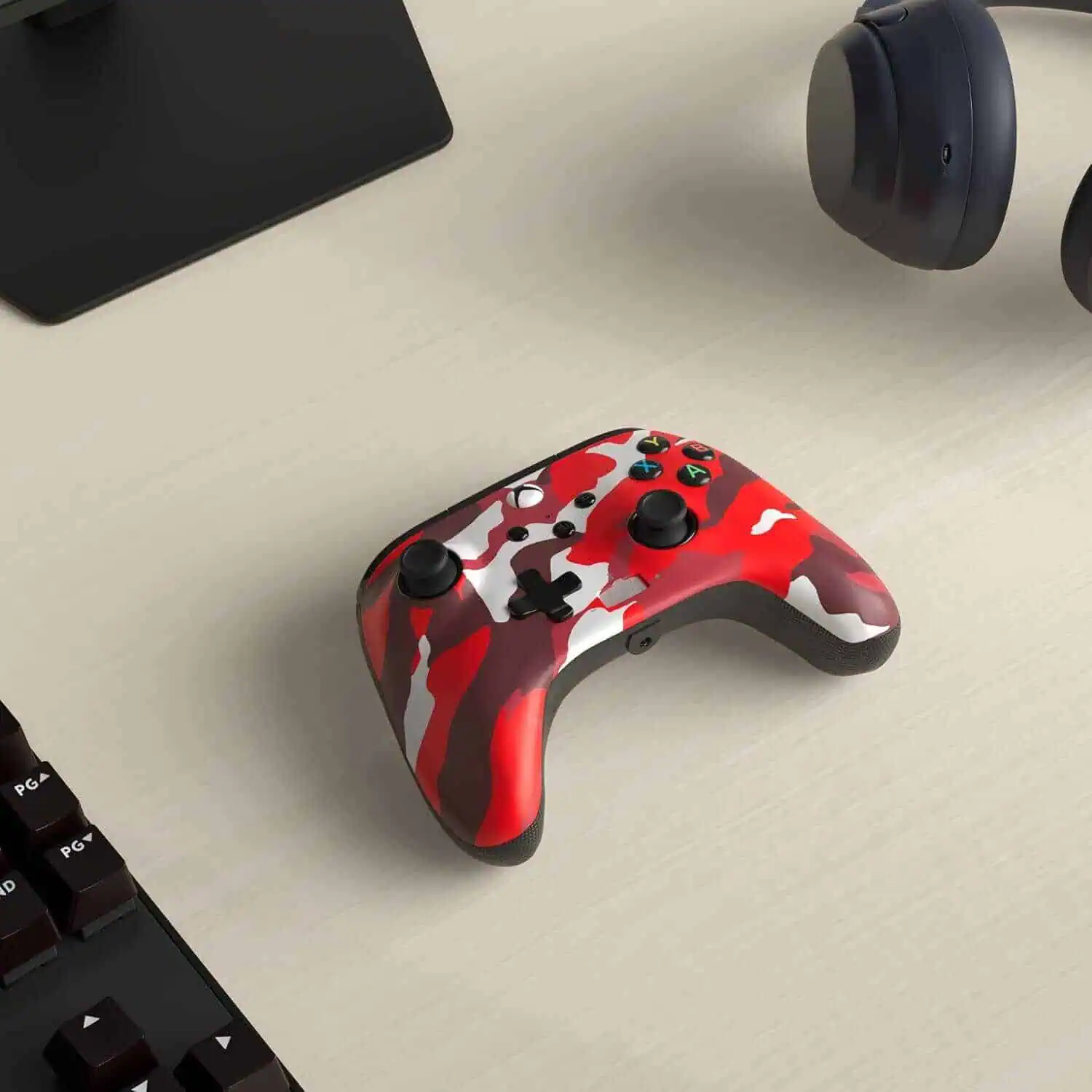 Red camo wired controller for Xbox Series X on desk.