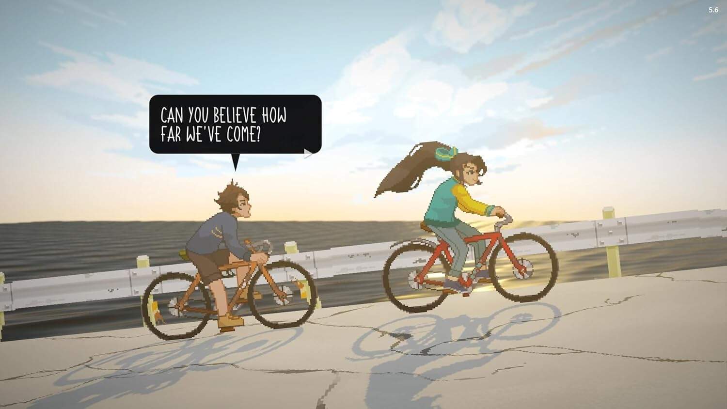 Two children riding bikes along the coast at sunset, enjoying the moment.