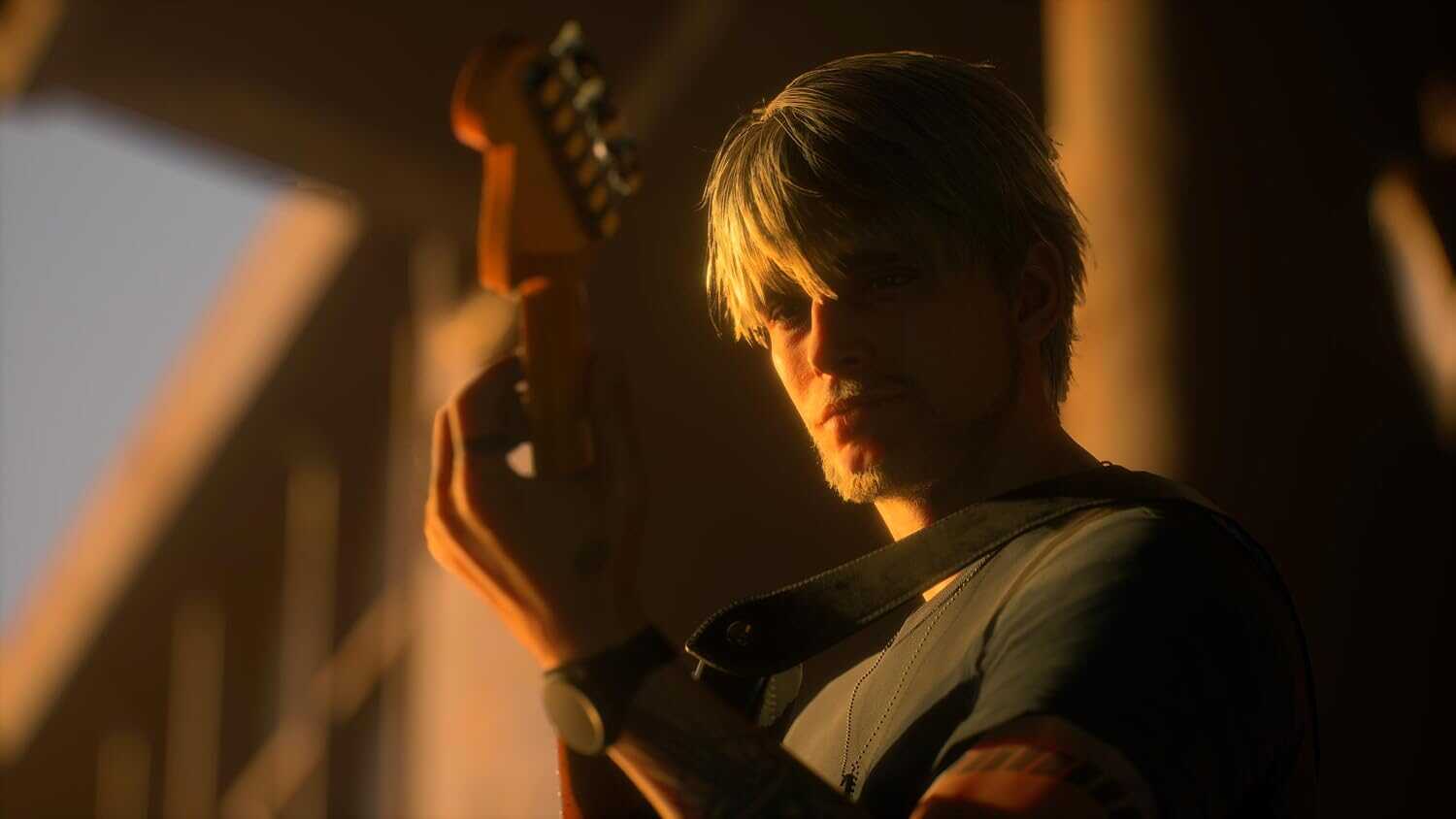 Young man playing electric guitar in warm, low-light setting.