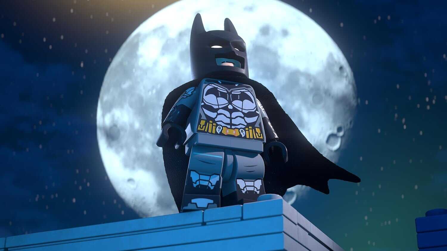 LEGO Batman figure with cape against a full moon background.