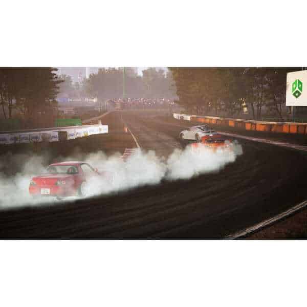 Drifting cars on a dirt track with smoke and dust at a racing event.