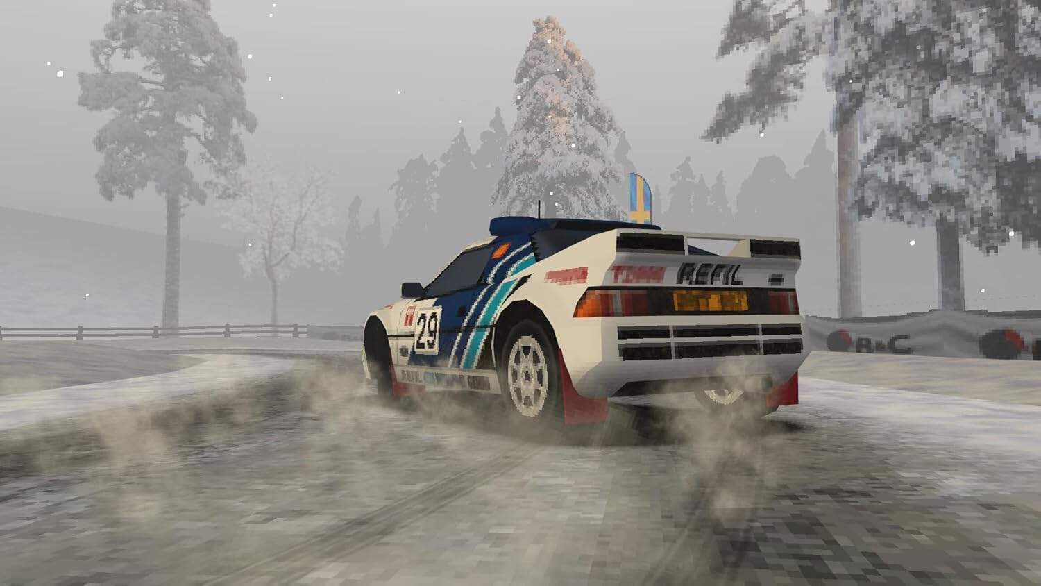Rally car drifting on snowy track with trees in the background.