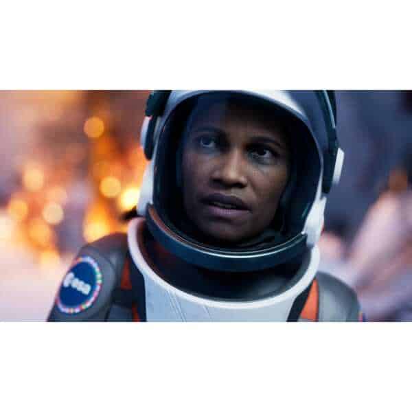 Astronaut wearing a helmet, ready for space exploration, with a blurred fiery background.