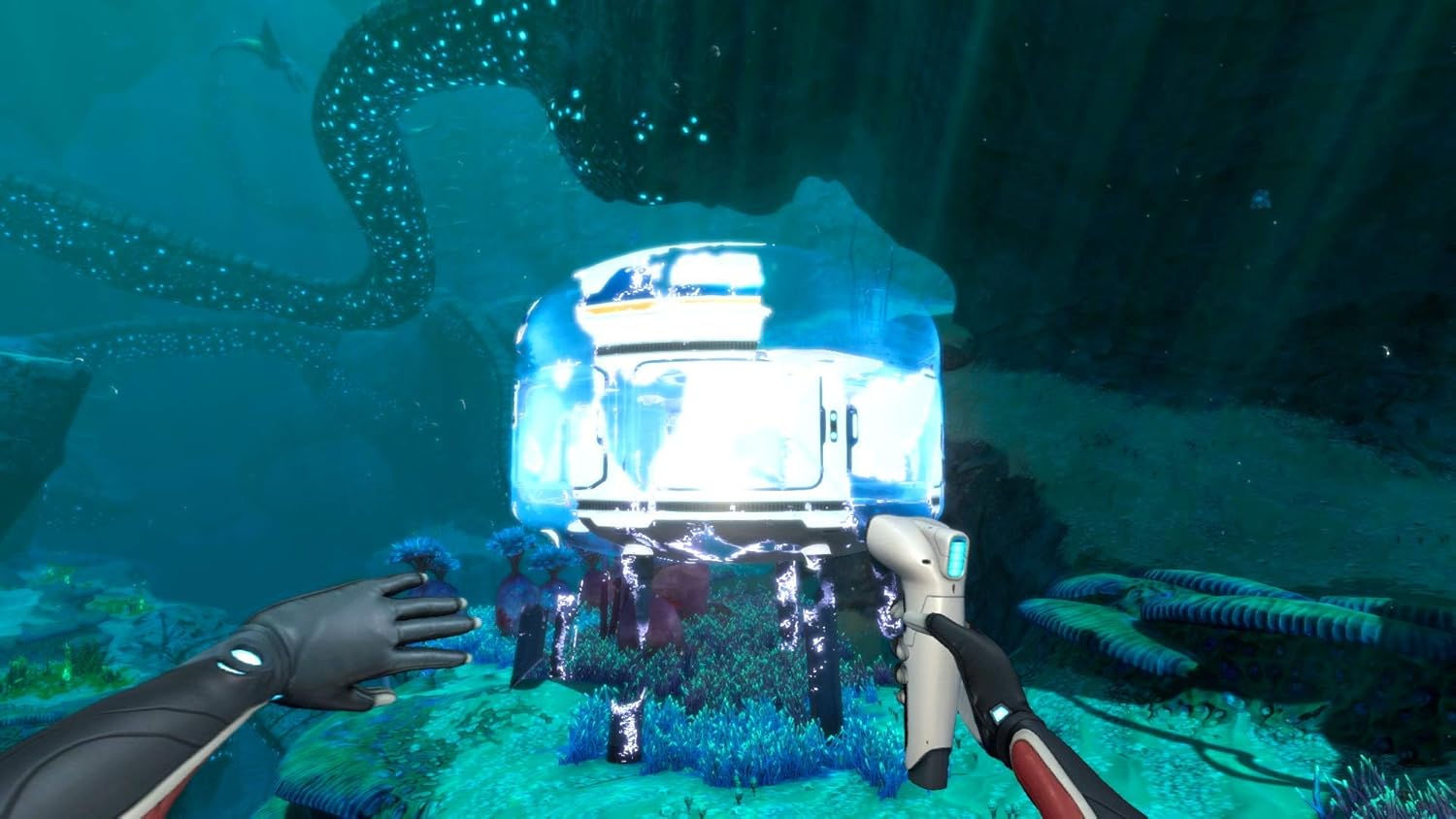 Underwater robot exploring coral reef with divers and marine life.