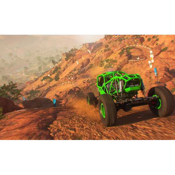 High-performance off-road racing vehicle navigating rugged terrain in a desert landscape.