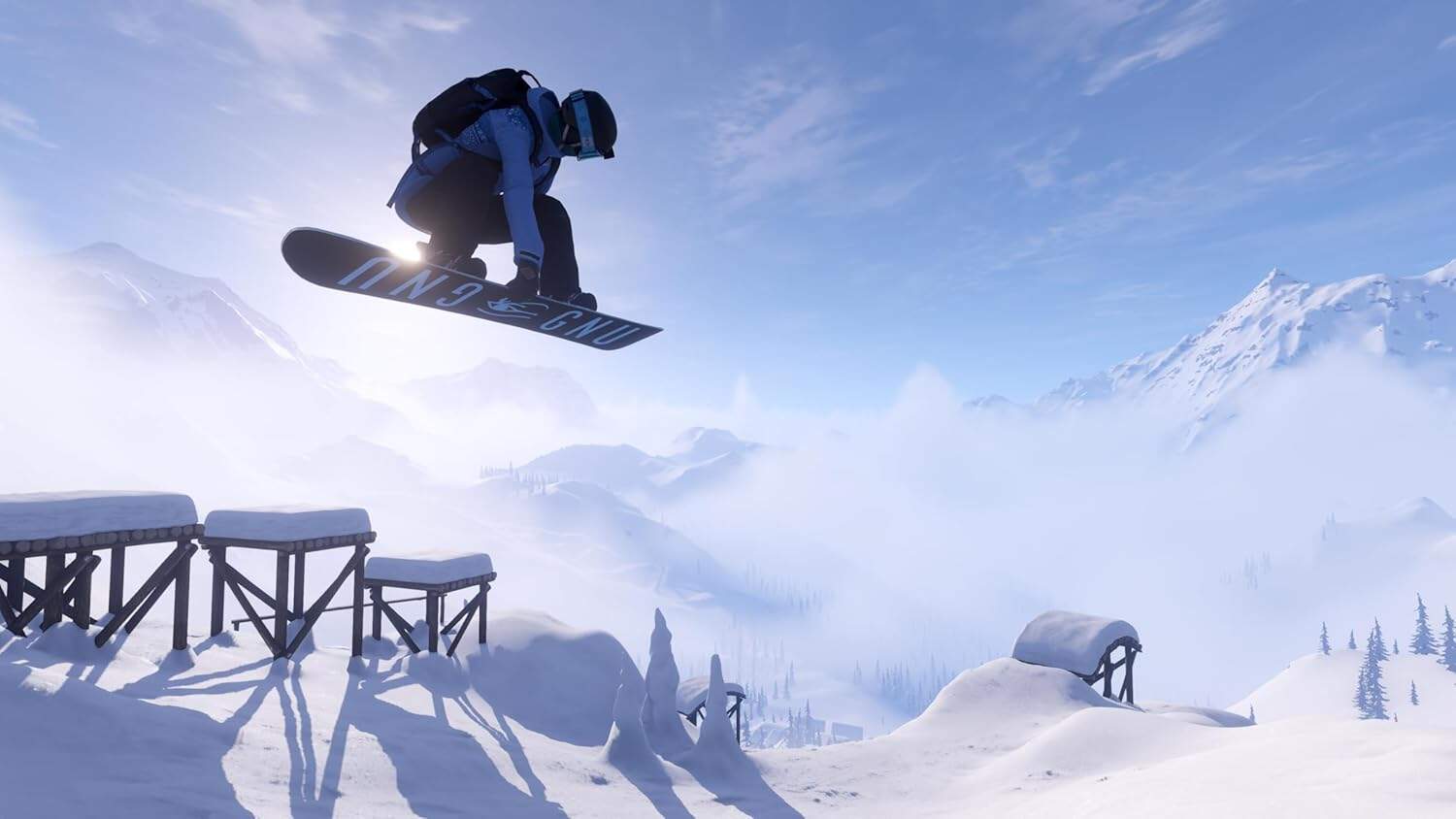 An adventurous snowboarder jumps over snow obstacles in a snowy mountain landscape.