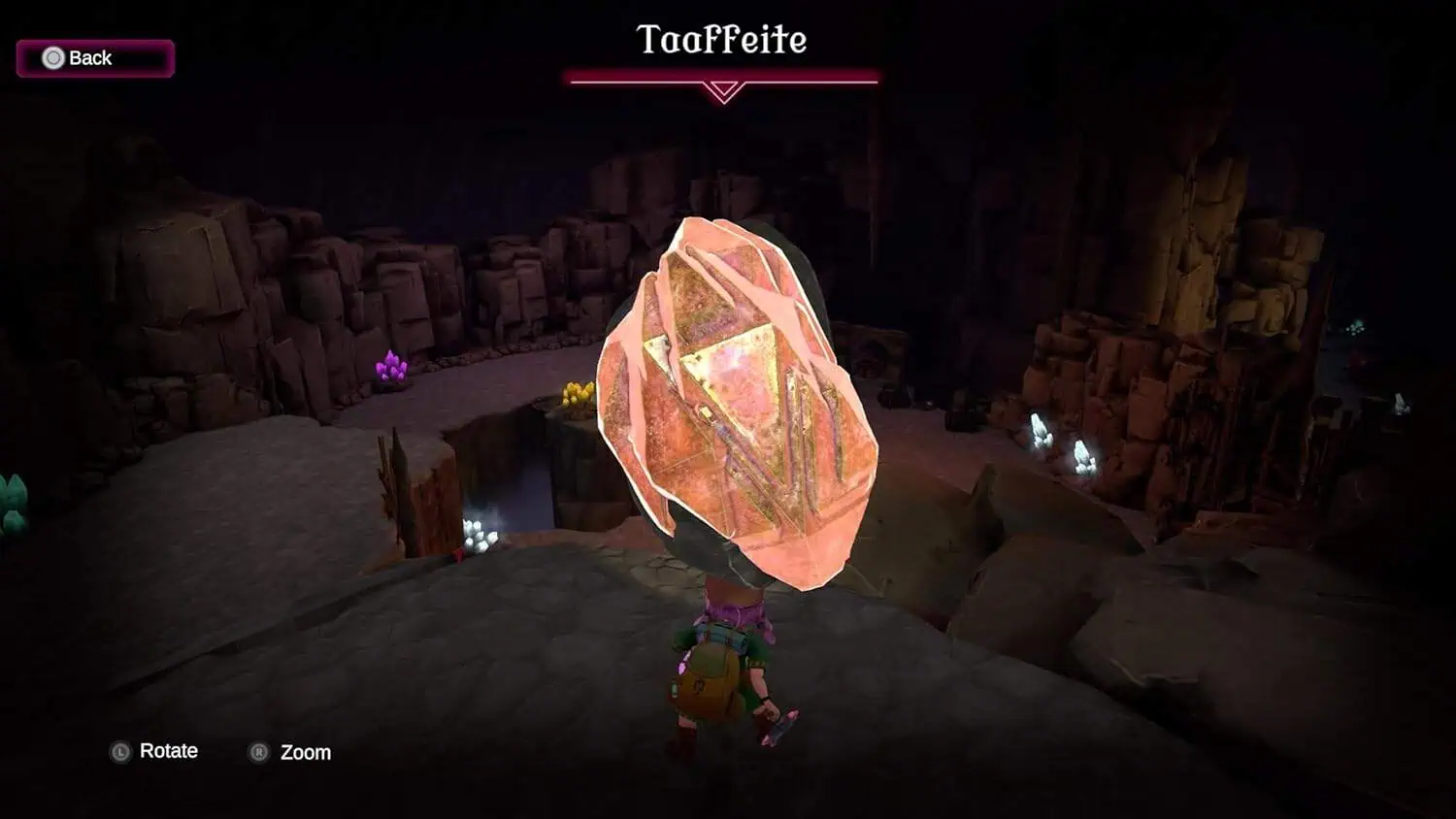 Glowing pink crystal in a dark fantasy game scene.