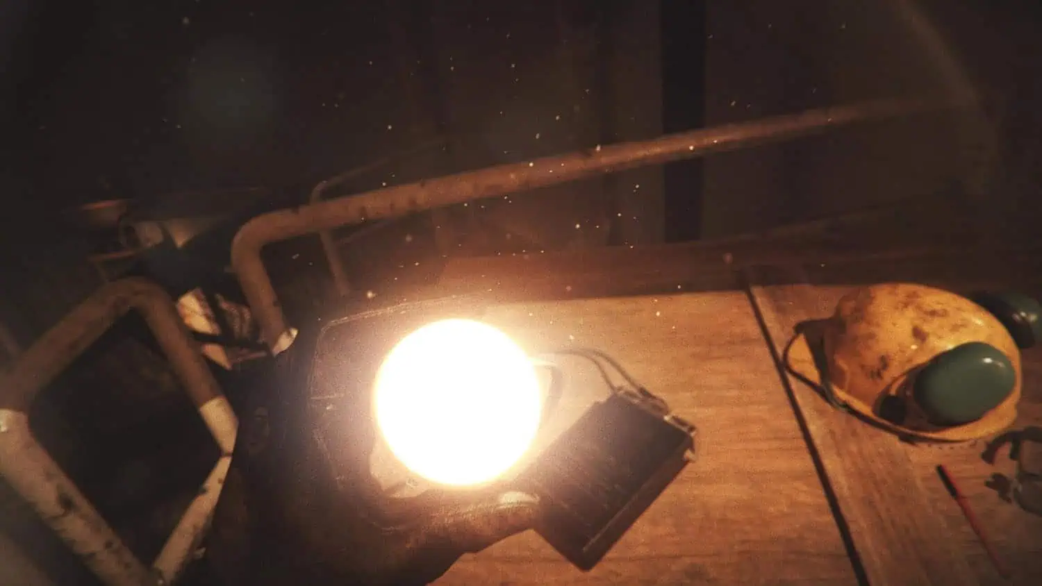 Close-up of a bright light source on a wooden table with gaming accessories.