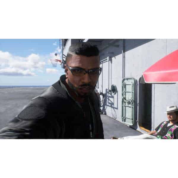 Close-up of a man on an aircraft carrier deck with sunglasses.