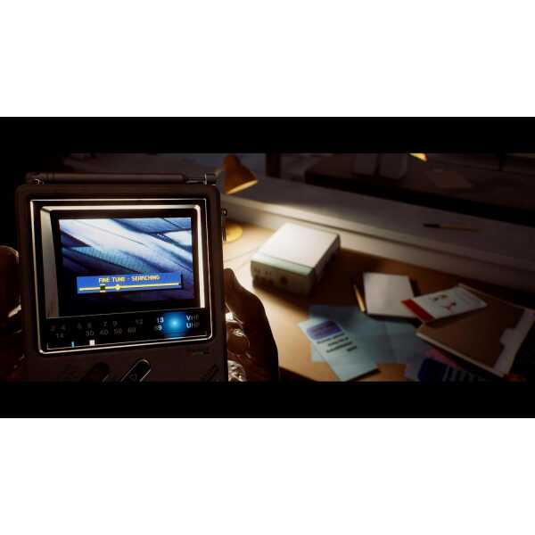 Close-up of a handheld device searching for signals in a dark room.