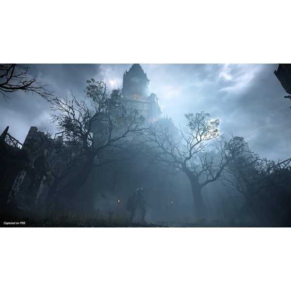 Haunted castle shrouded in fog with eerie trees and dark atmosphere.