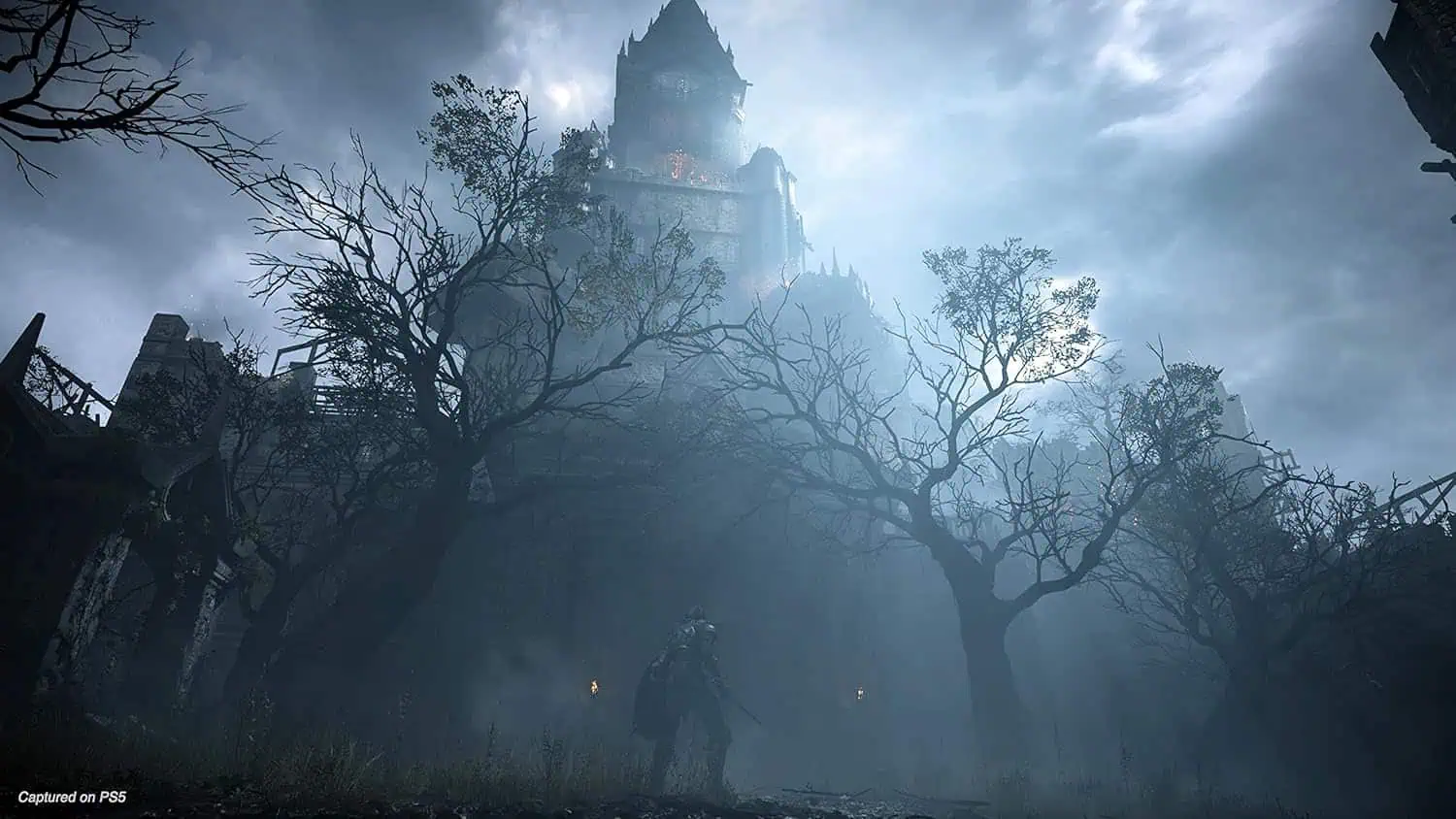 Haunted castle shrouded in fog with eerie trees and dark atmosphere.