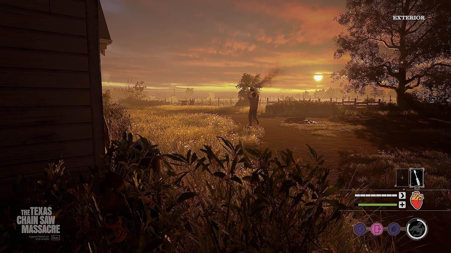Sunset over rural landscape with trees and open field, capturing a peaceful outdoor environment.