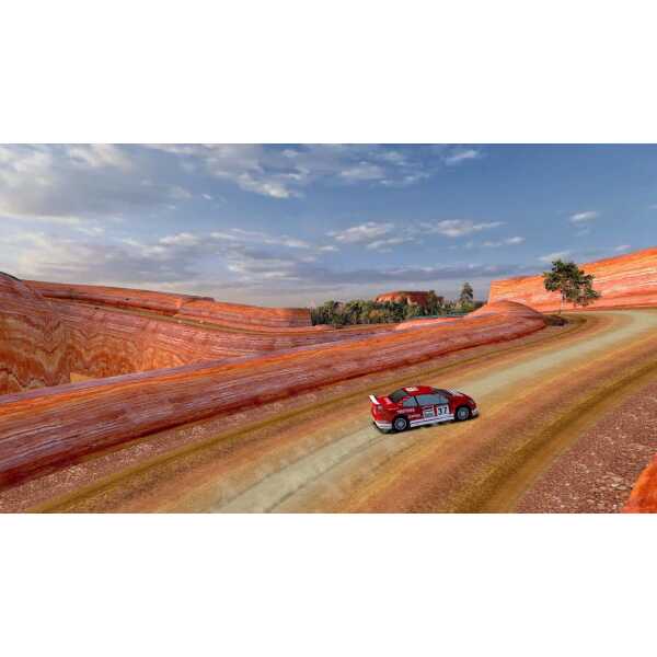 Classic rally car driving on a winding desert road with red rock formations.