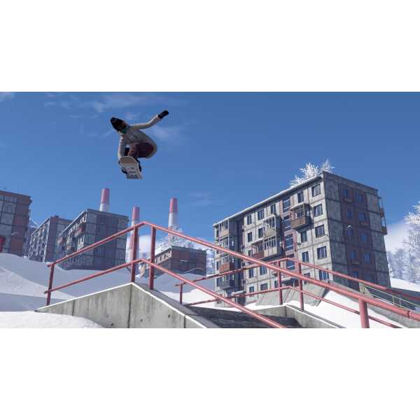 Snowboarder performing a jump over a railing in a snowy urban environment.