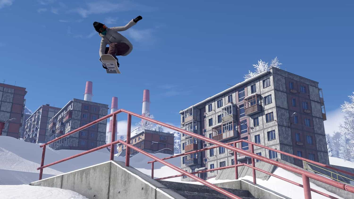 Snowboarder performing a jump over a railing in a snowy urban environment.