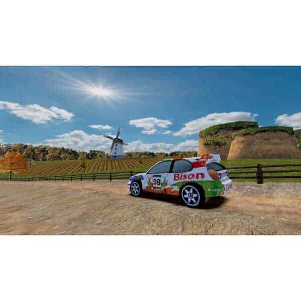 Classic rally car with "Bison" livery on rural dirt road under blue sky.