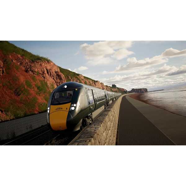 Modern train traveling along a scenic coastal railway route at sunset.