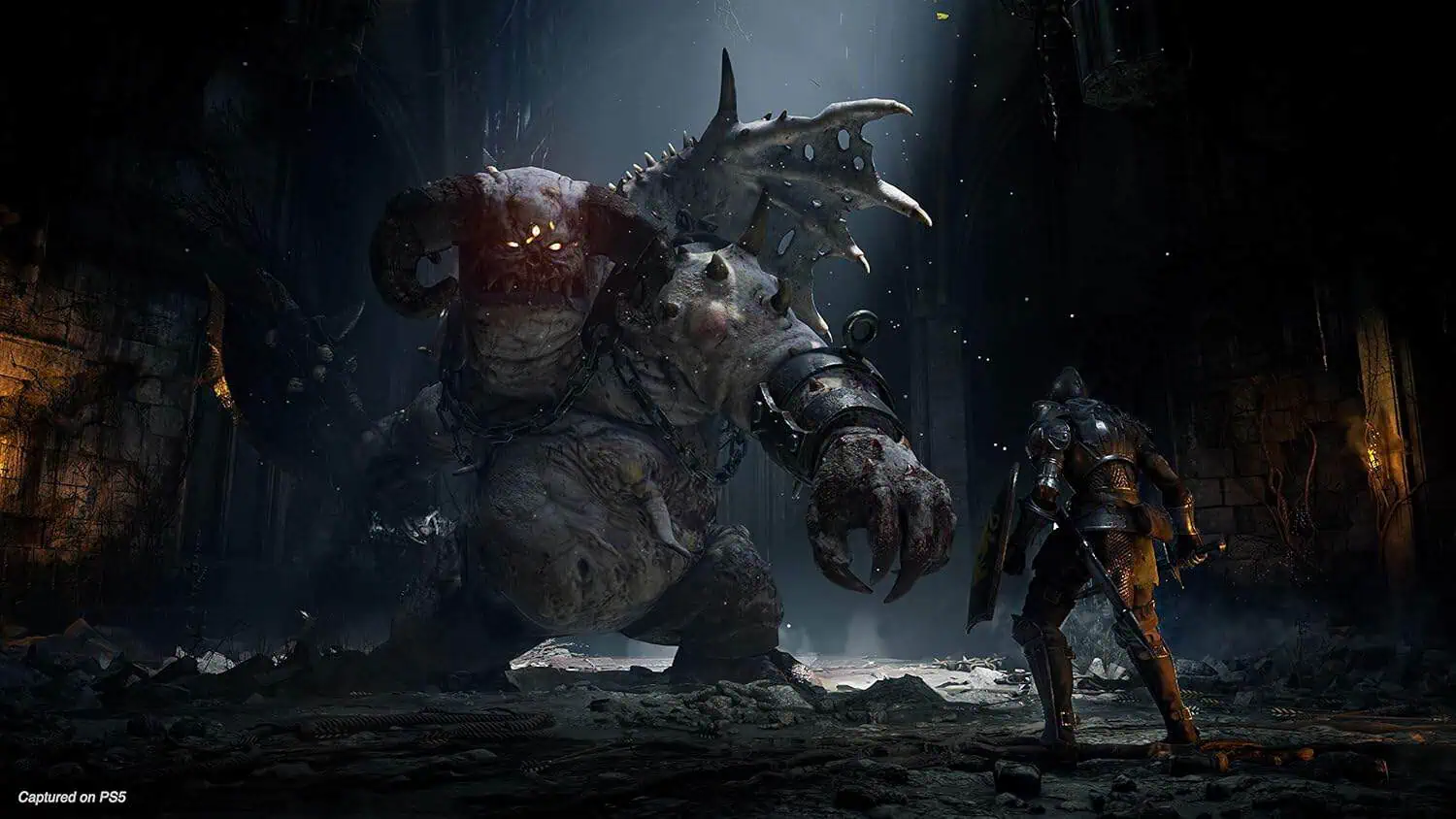 Massive monster fighting hero in dark, ruined cityscape.