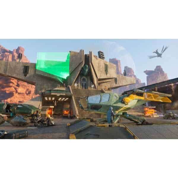 Futuristic military base from Dune: Awakening game with vehicles and aircraft.