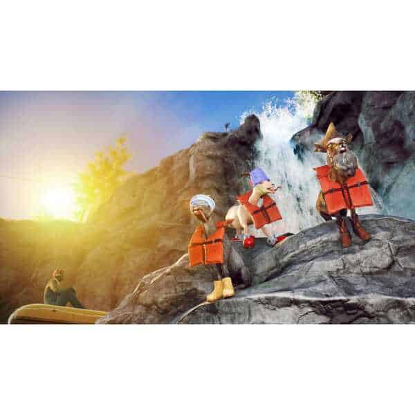 Three goats in life jackets climbing rocks near a waterfall at sunset.