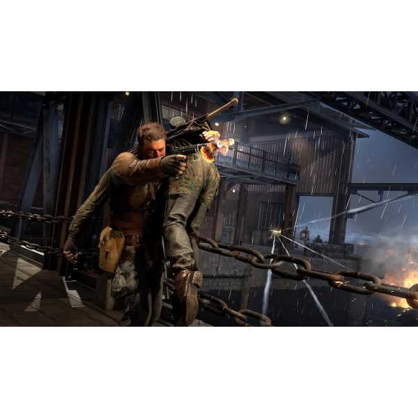 Action-packed gaming scene with a soldier firing a weapon in a rainy industrial setting.