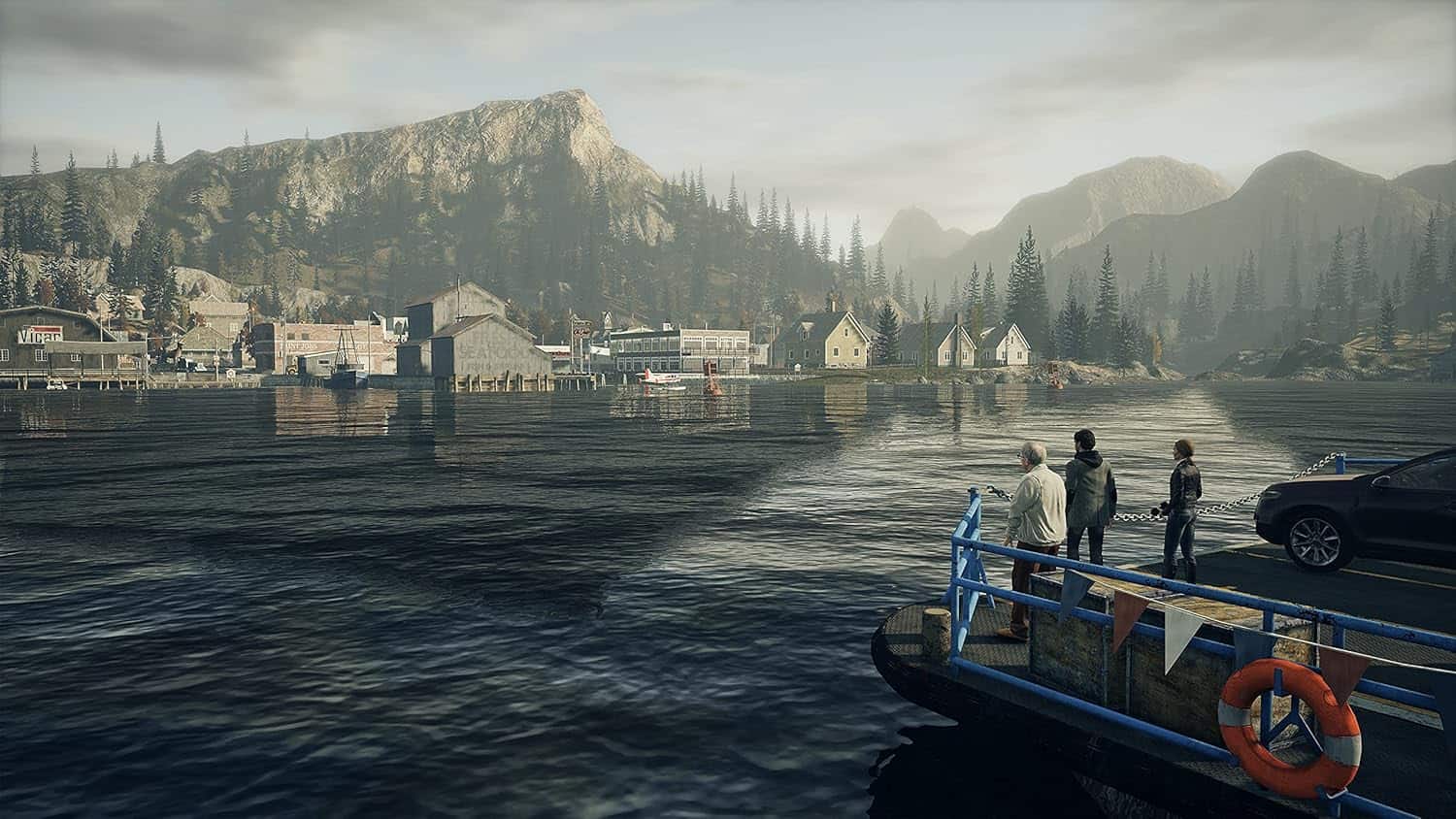 Scenic view of a lakeside town with mountains in the background, featuring four people on a boat doc.