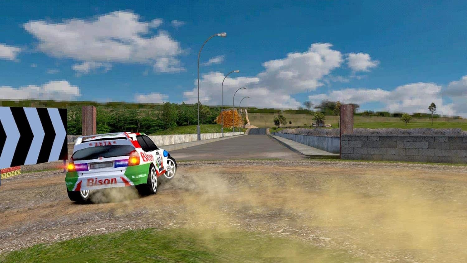 Rally car speeding on dirt road during an old school rally event.