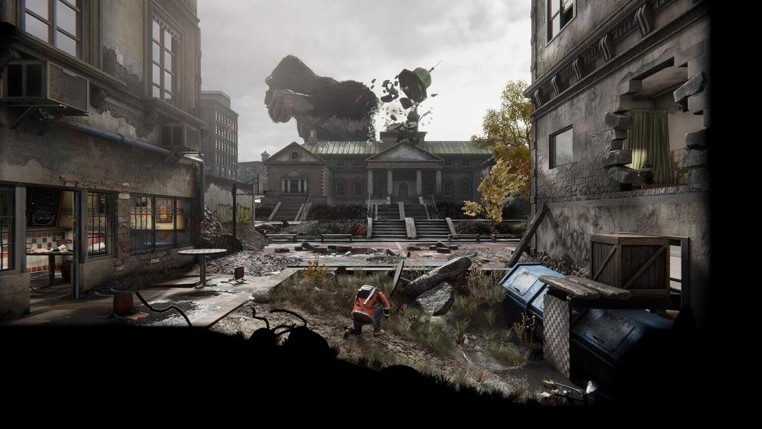 Destruction scene from Kong: Survivor Instinct game with city ruins and monster in background.