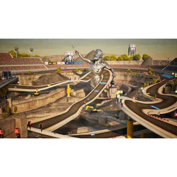 Indoor go-kart racing track with a large statue and winding tracks for competitive fun.