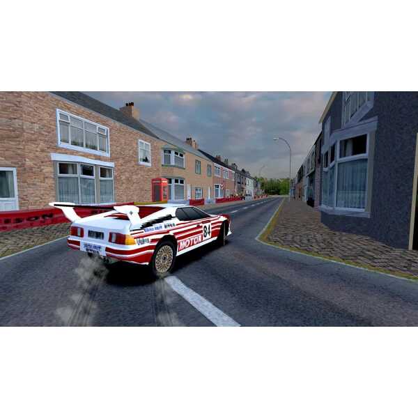 Rally car racing through a residential neighborhood with houses and cobblestone streets.