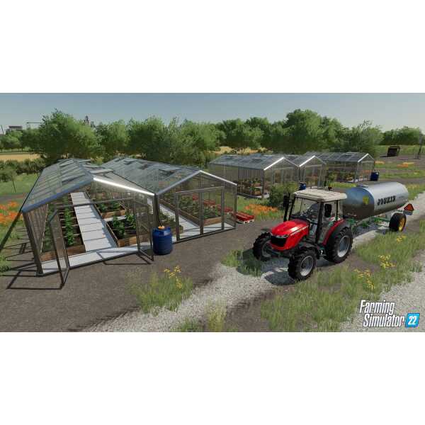 Greenhouse setup with tractor and water tank in Farming Simulator 22.