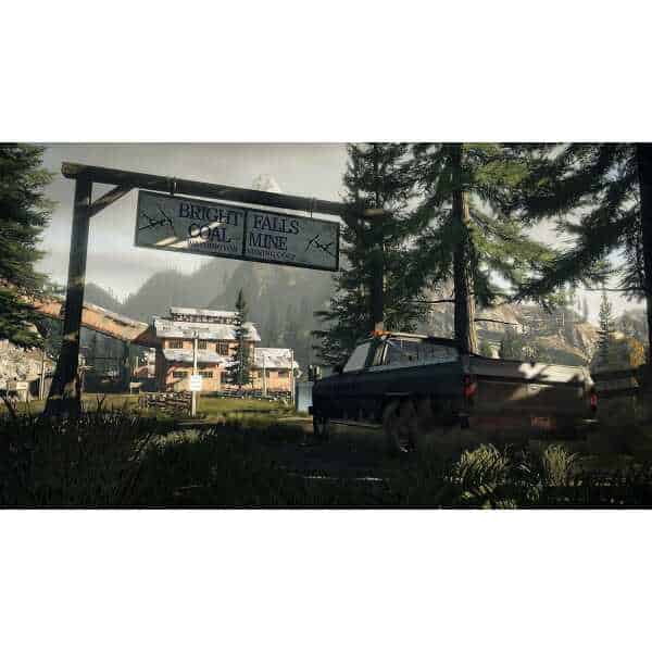 Mining town with a truck and signboard in a forested mountain area.