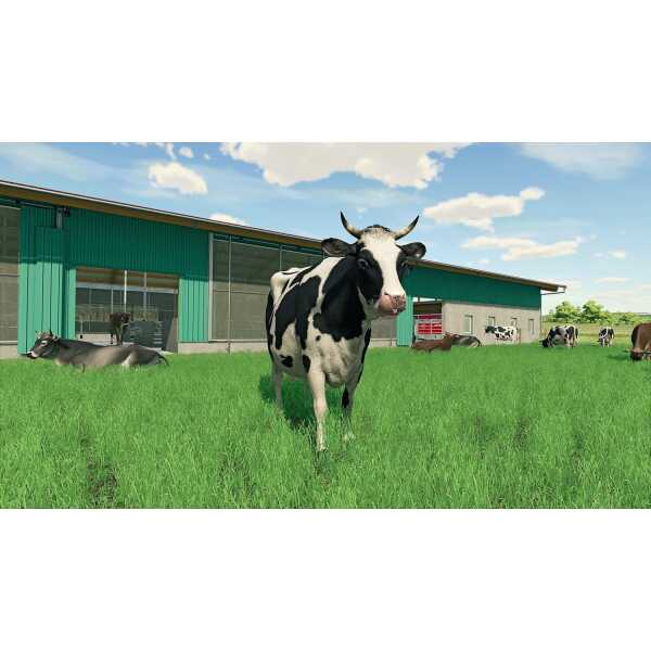 Cow standing on green grass near farm building in Farming Simulator 22.