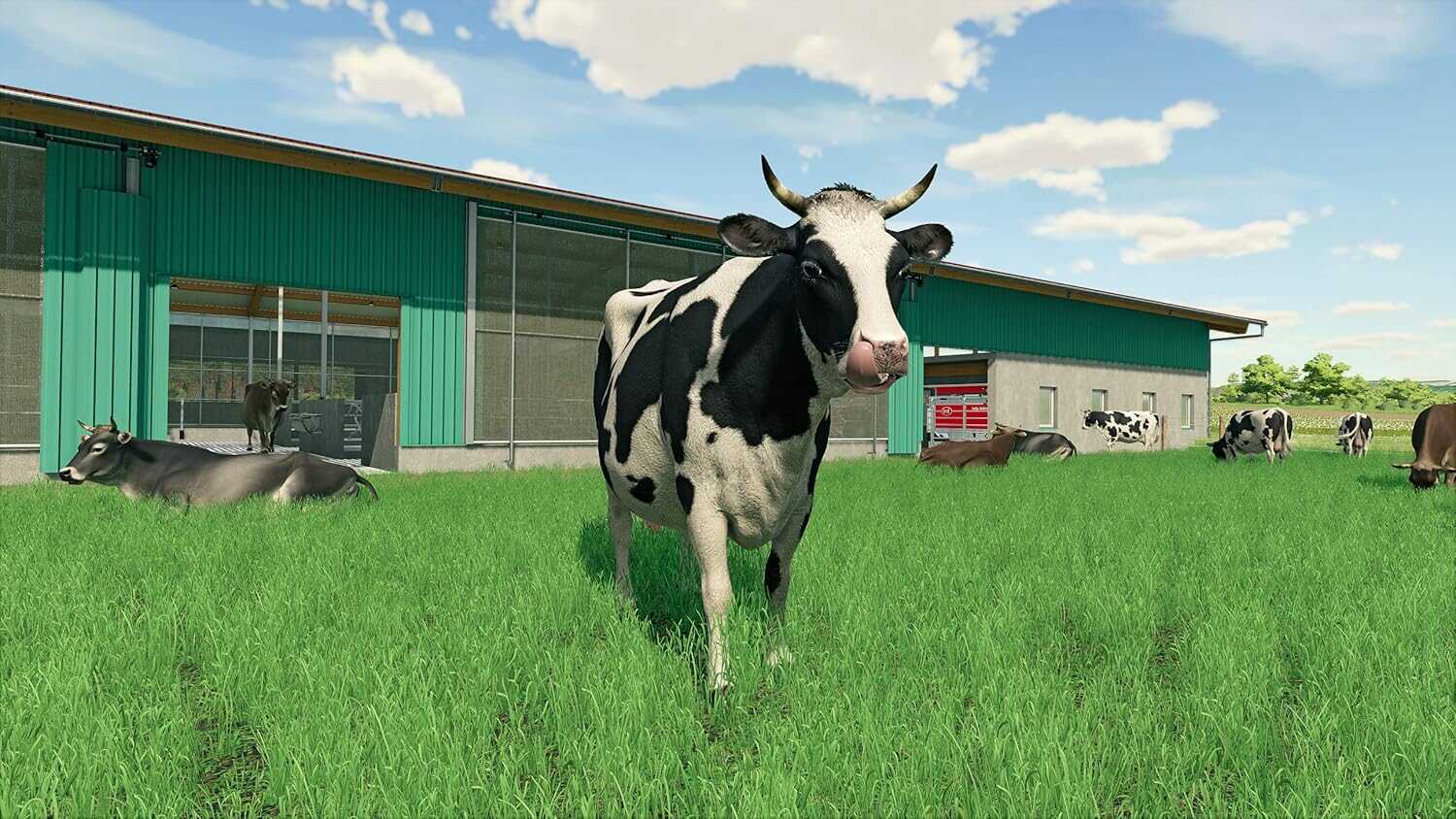 Cow standing on green grass near farm building in Farming Simulator 22.