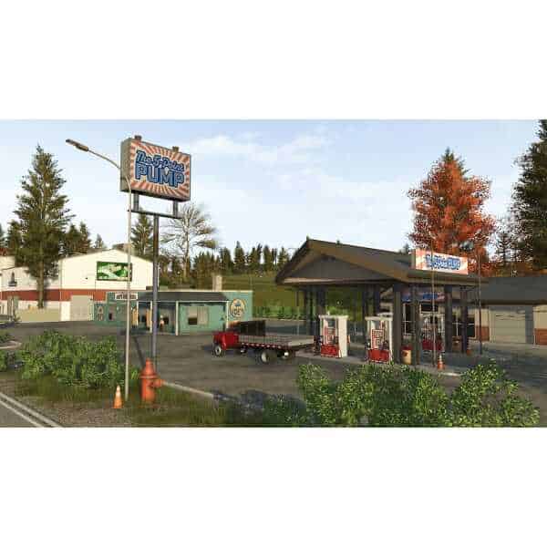 Modern gas station in Farming Simulator 26 with fuel pumps and vehicles.