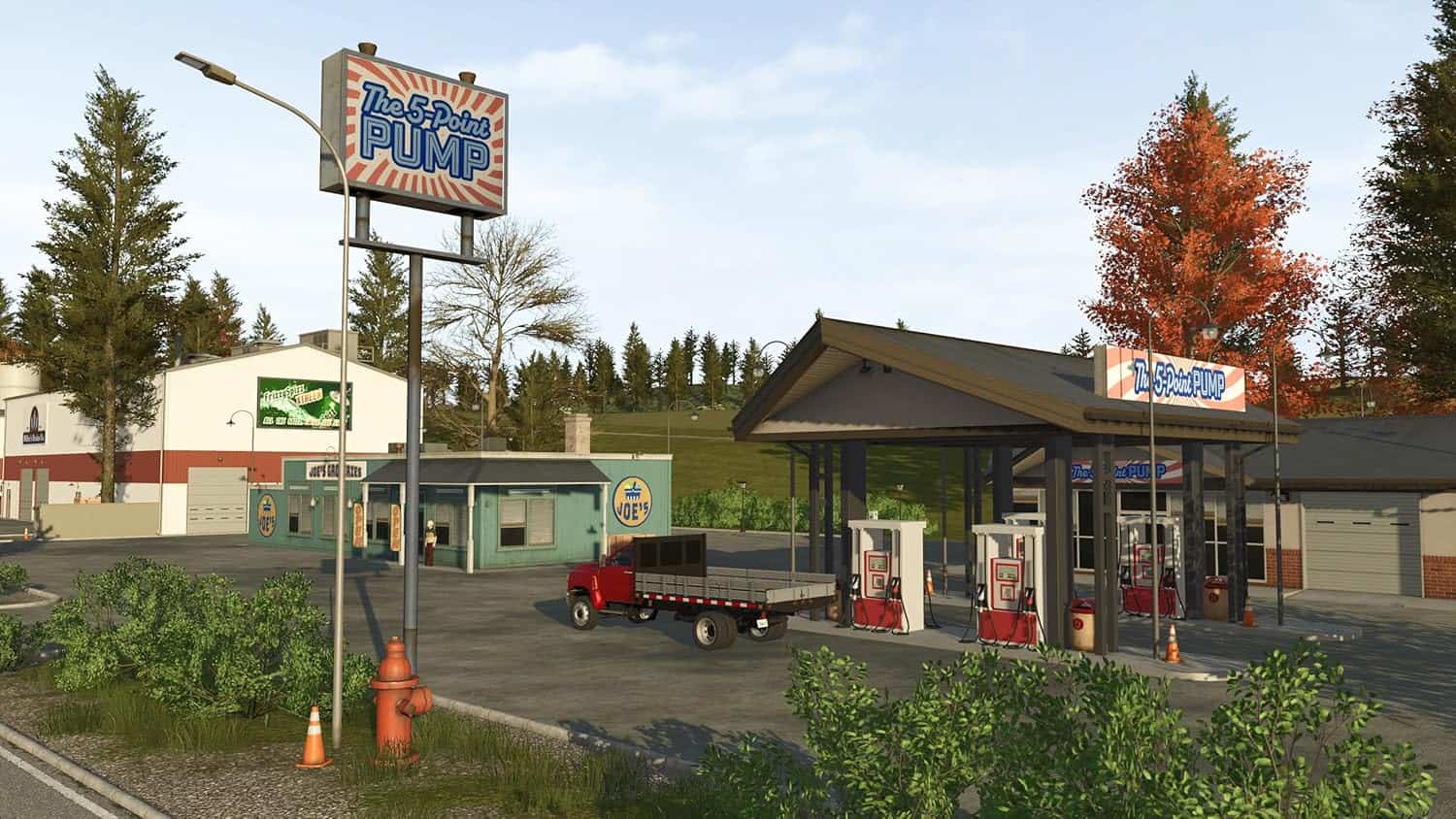 Modern gas station in Farming Simulator 26 with fuel pumps and vehicles.